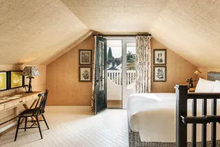 Hotel 850 SVB is a hotel with a home-like feel and stunning views of Los Angeles, as captured in this bedroom shot, constellated by furniture accents and textured walls.