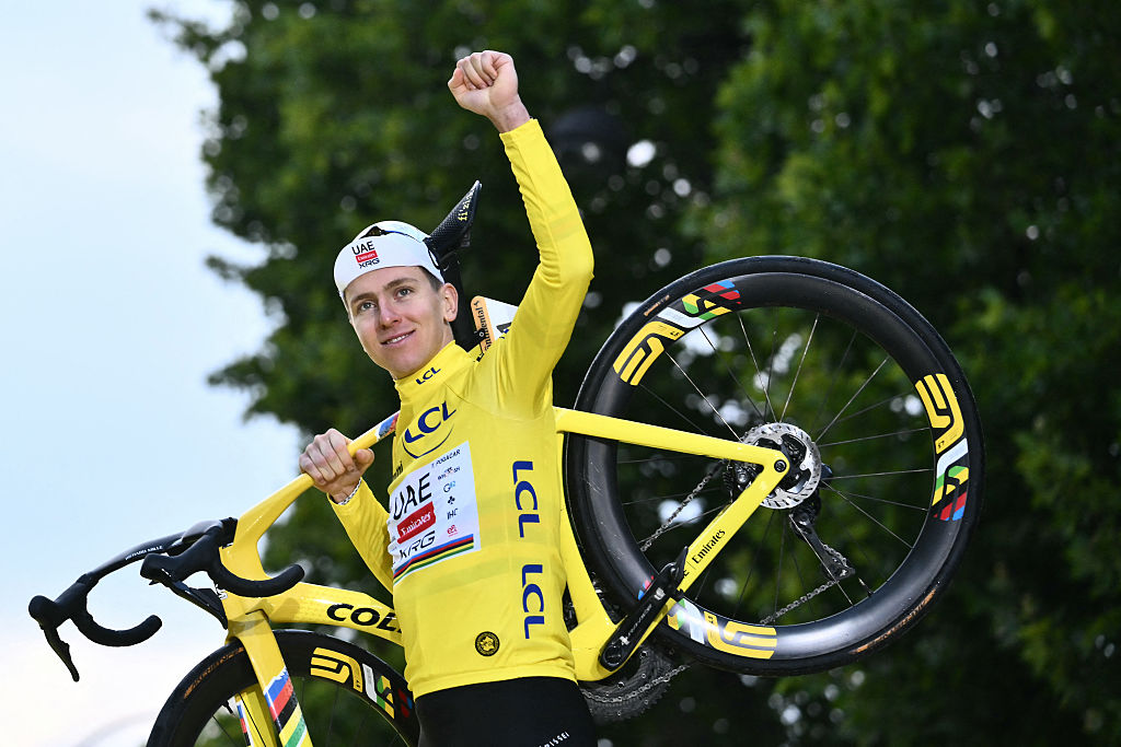 UAE Team Emirates - XRG team&#039;s Slovenian rider Tadej Pogacar celebrates on the podium with the overall leader&#039;s yellow jersey after the 21st and final stage of the 112th edition of the Tour de France cycling race, 132.3 km between Mantes-la-Ville and Paris Champs-Ã‰lysees, on July 27, 2025. (Photo by Marco BERTORELLO / AFP)