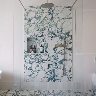 Bathroom with green and white marble in open shower