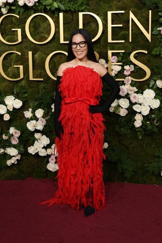 Celebrity wears a dark red dress to the Golden Globes 2025.