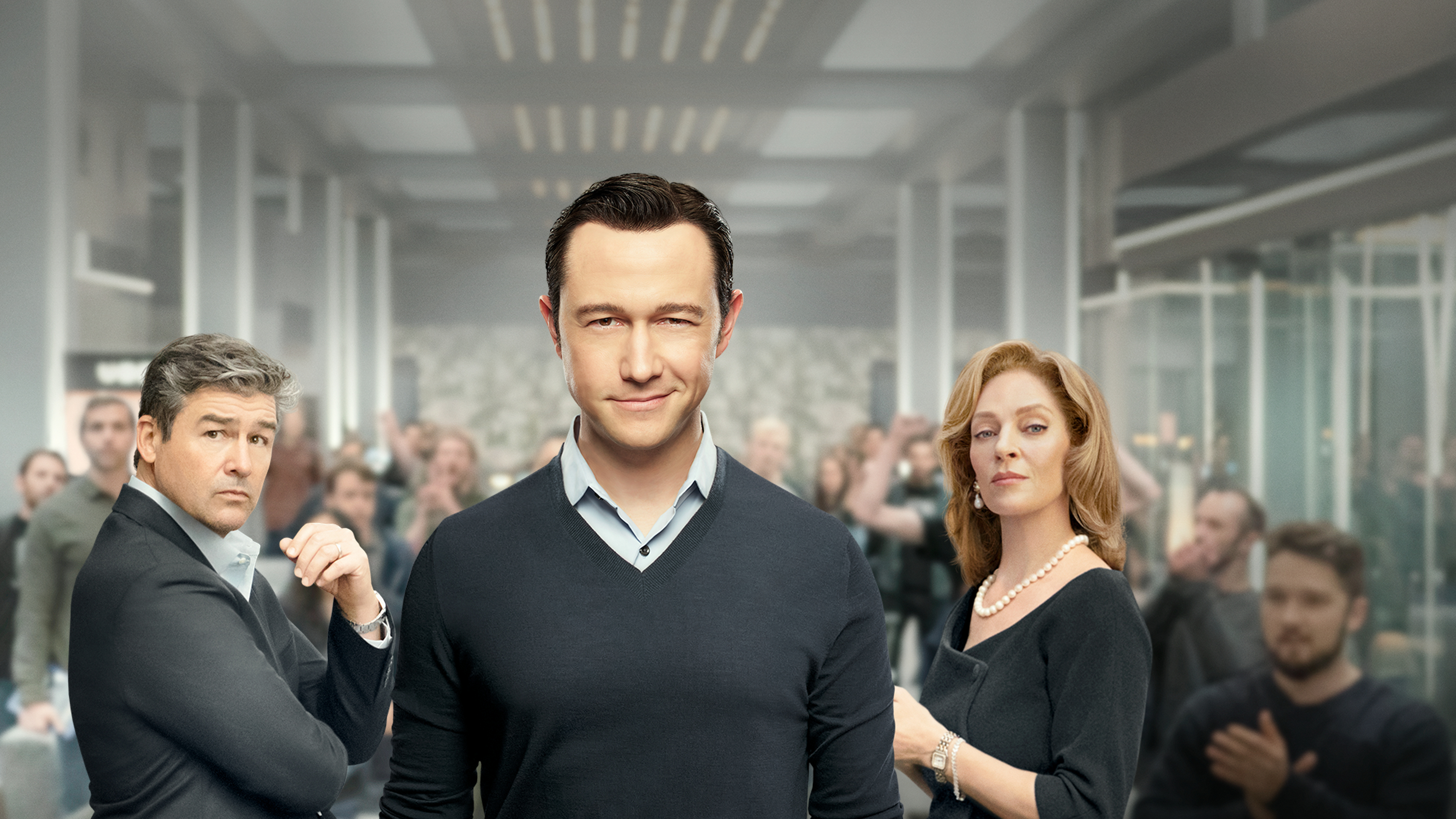 Joseph Gordon-Levitt smirking at the camera with Kyle Chandler and Uma Thurman standing on either side of him.