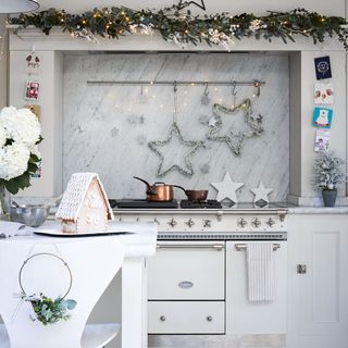 white kitchen with Christmas decorations above the stove