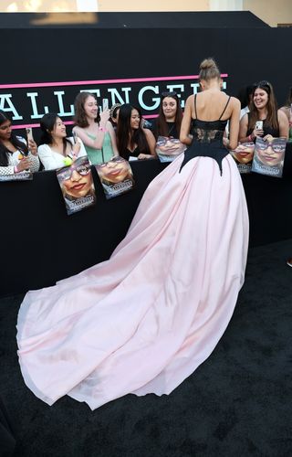 Zendaya signing autographs at the Challengers Los Angeles premiere in a custom vera wang gown