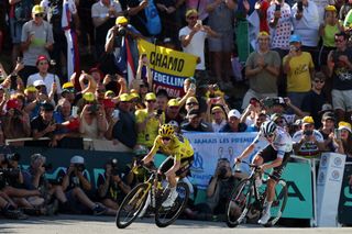 Jumbo-Visma's Danish rider Jonas Vingegaard wearing the overall leader's yellow jersey (L) and UAE Team Emirates' Slovenian rider Tadej Pogacar wearing the best young rider's white jersey cycle to the finish line of the 15th stage of the 110th edition of the Tour de France cycling race, 179 km between Les Gets Les Portes du Soleil and Saint-Gervais Mont-Blanc, in the French Alps, on July 16, 2023. (Photo by Thomas SAMSON / AFP)