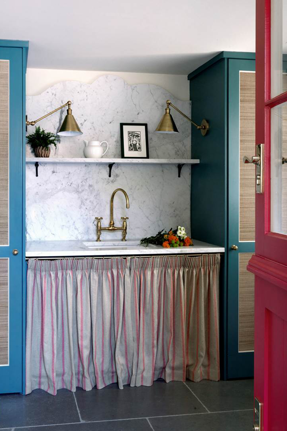 Striped kitchen sink skirt with white marble worktop and backsplash