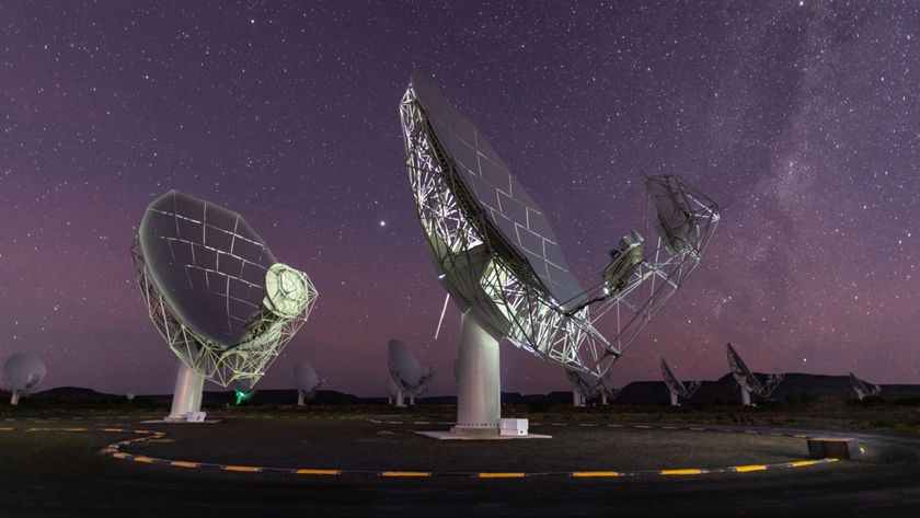 A photo of two radio dishes pointed up at the night sky