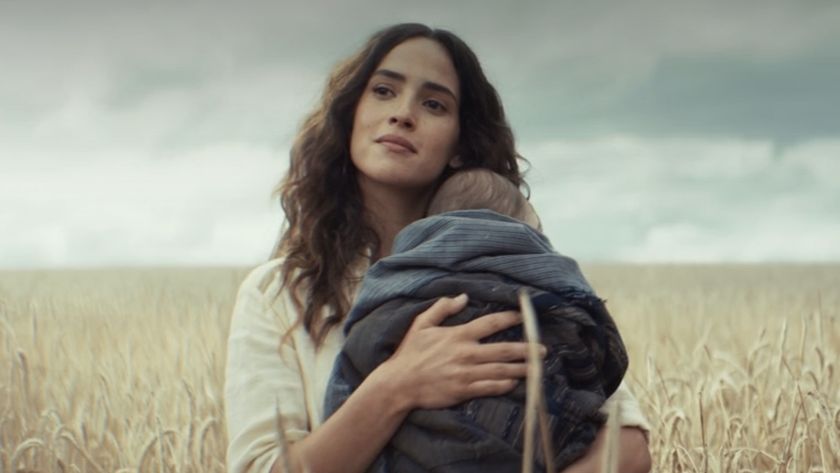 Adria Arjona&#039;s Bix holding her baby in the middle of a wheat field
