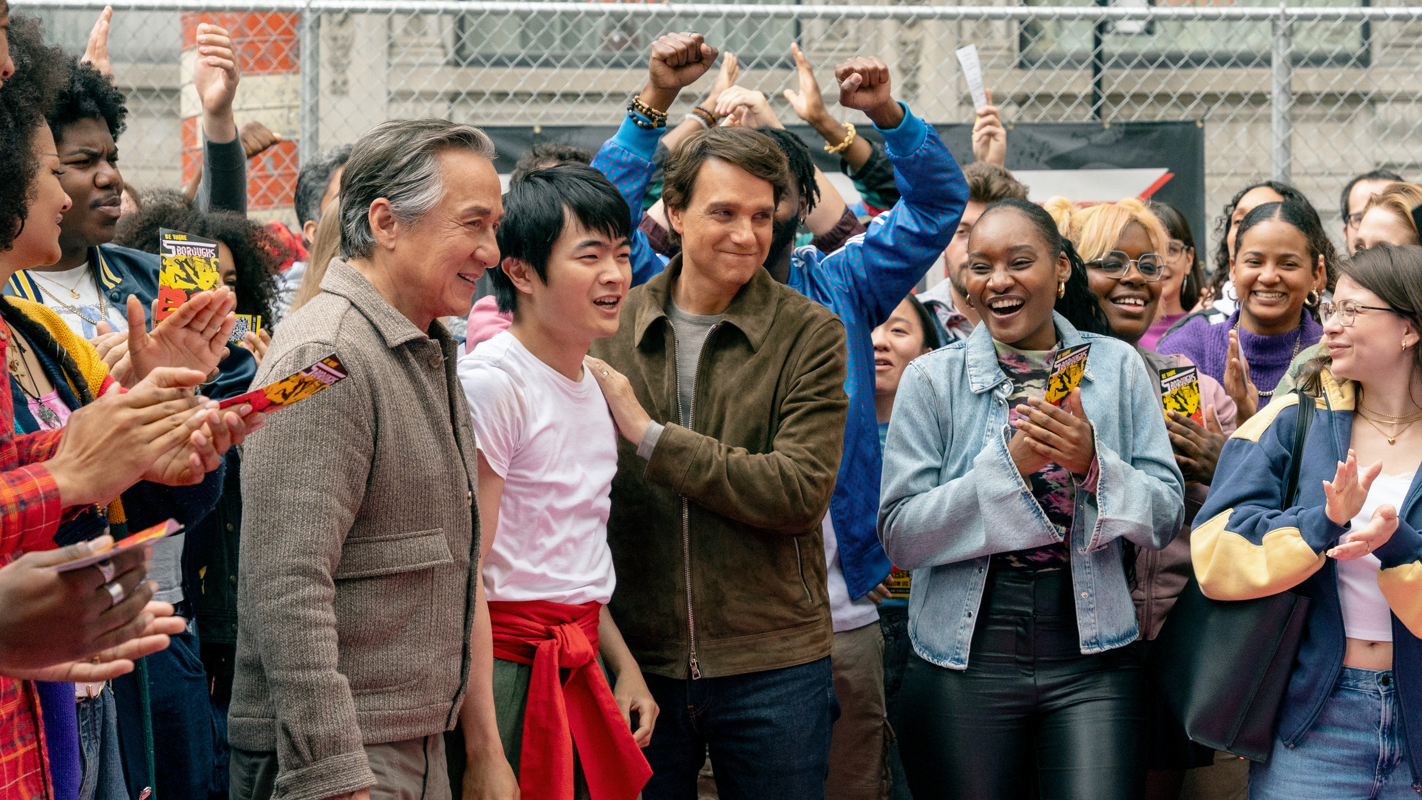 L-R: Mr. Han (Jackie Chan), Li Fong (Ben Wang) and Daniel LaRusso (Ralph Macchio) seen together in a crowd scene from &quot;Karate Kid: Legends&quot;