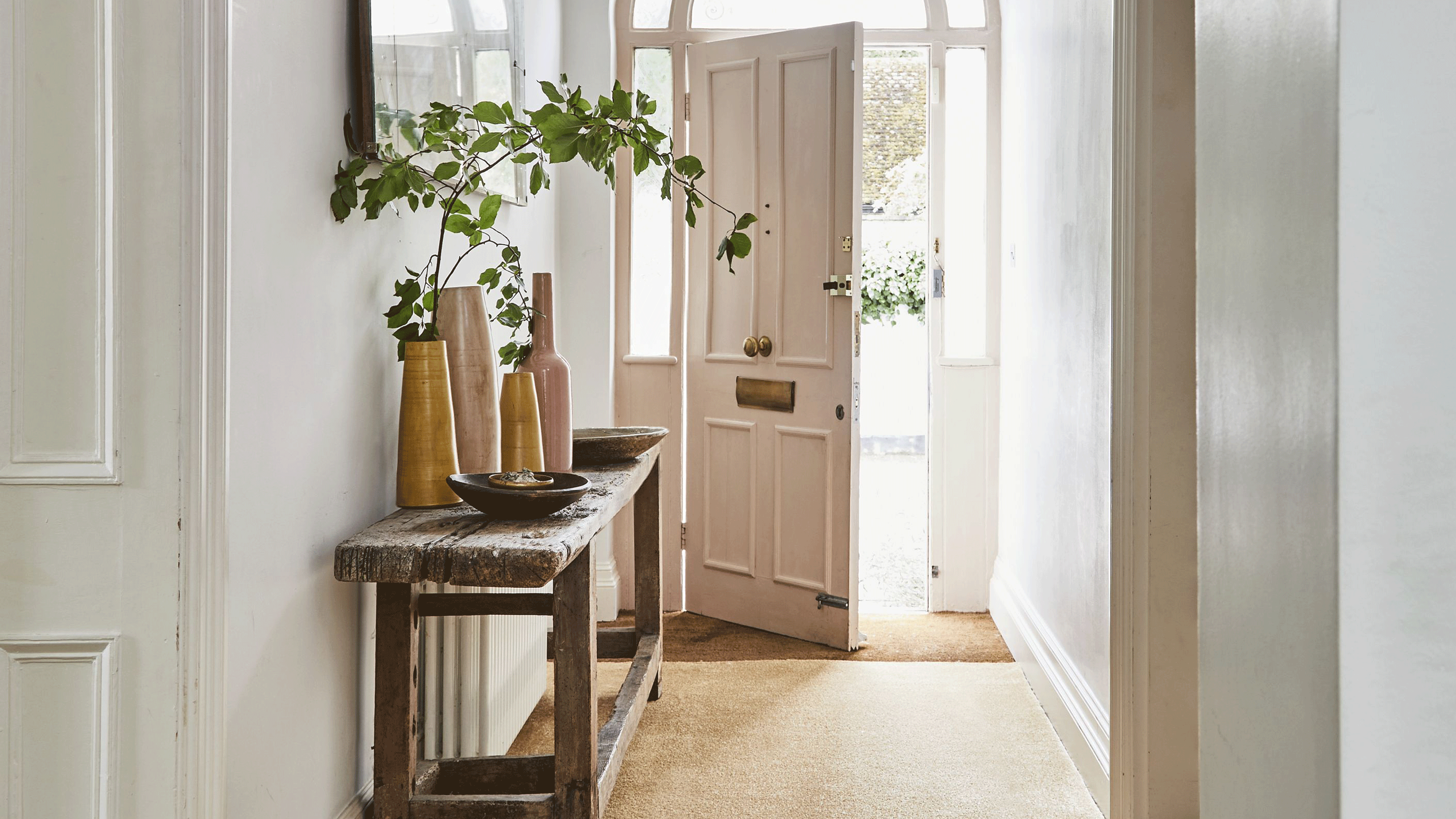 hallway with side table and pink door