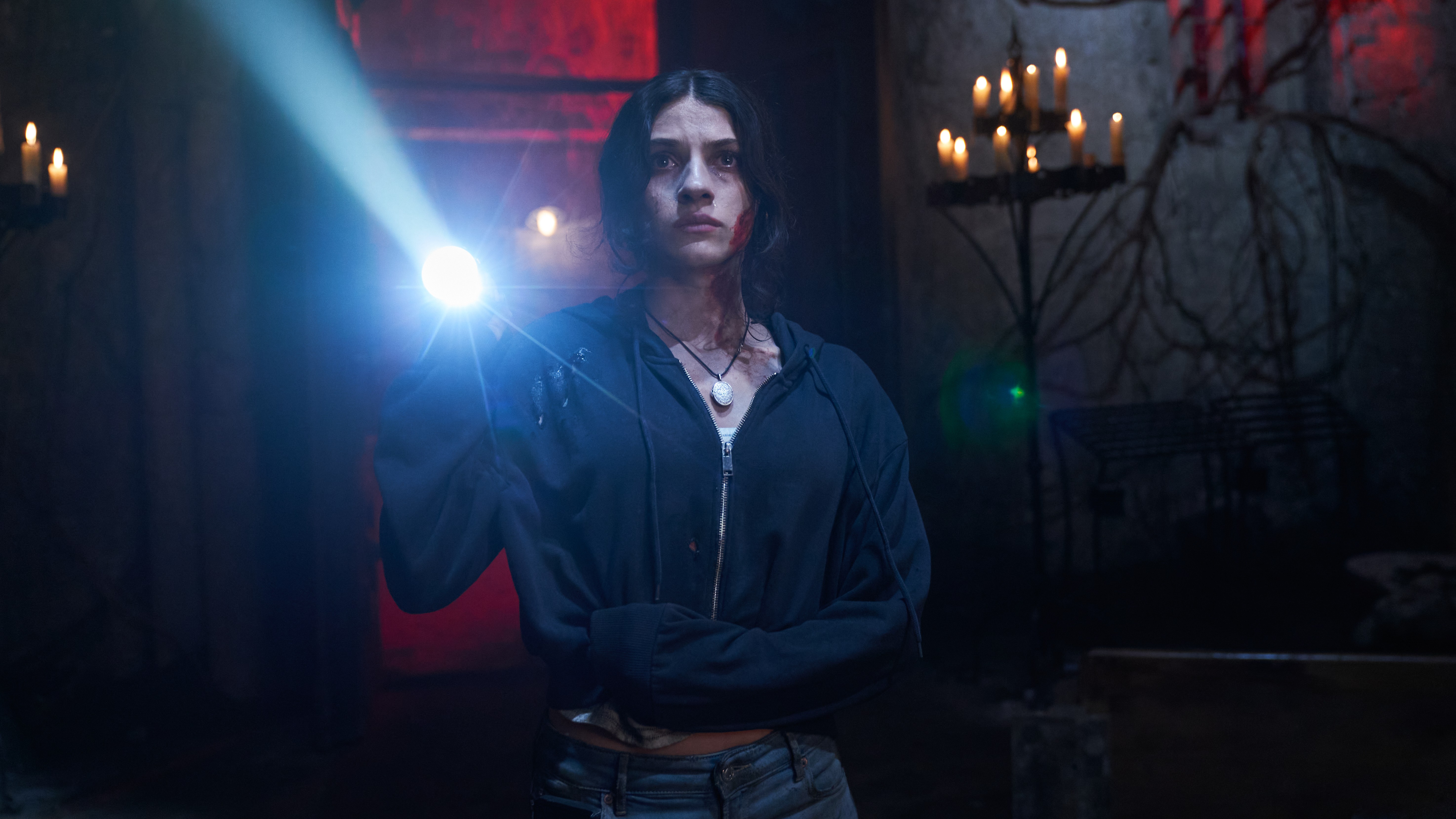 Ella Rubin holds a flashlight in a scene from the "Until Dawn" movie