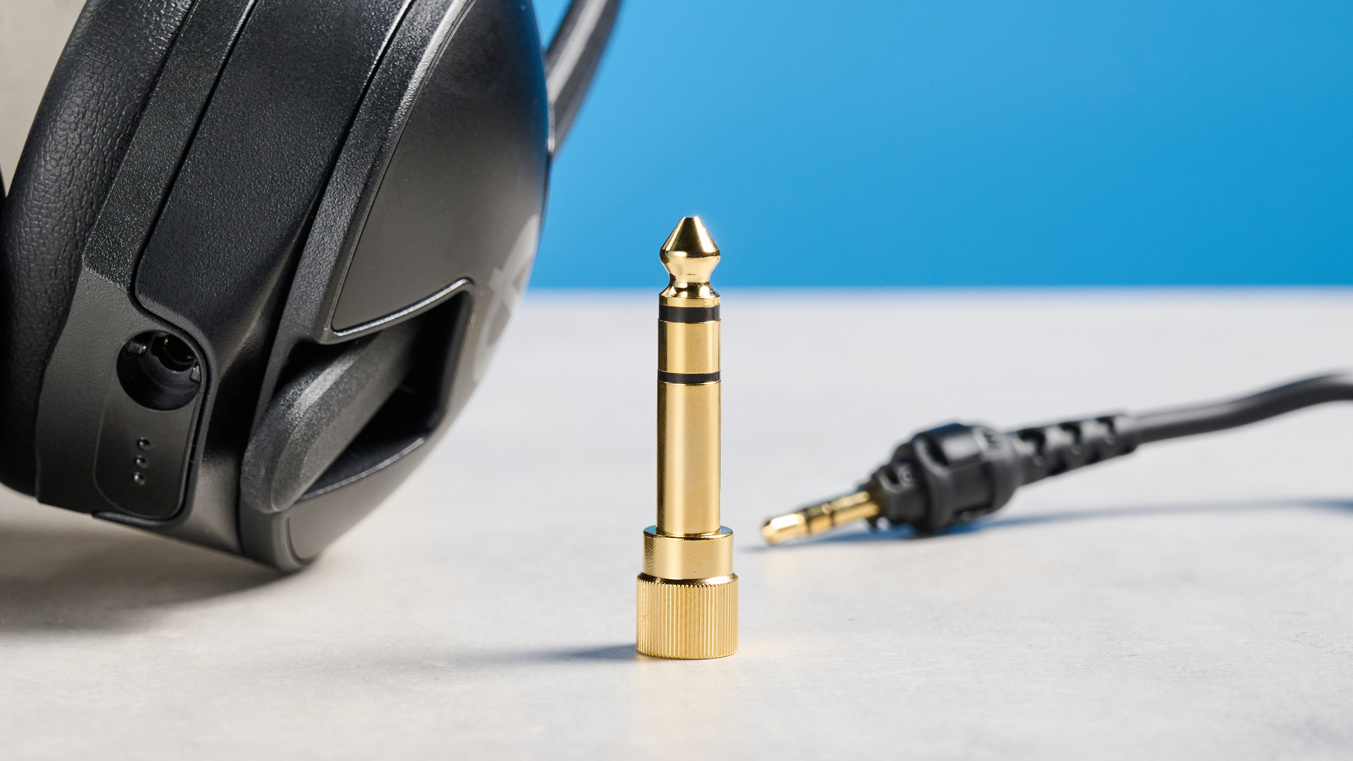 the rode nth-50 studio headphones in black showing the long cable, 3.5mm jack, 1/4 jack, and in use