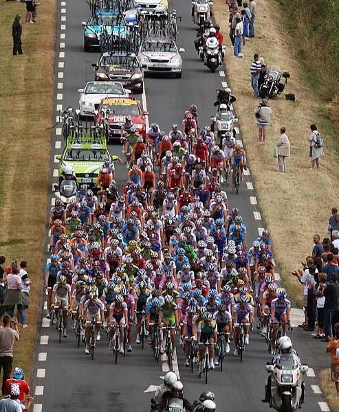 The peloton is bunched together tightly.