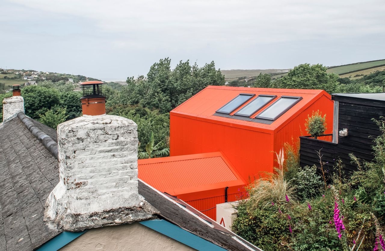 Orange extension with skylights attached to a cottage