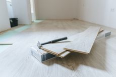 Installing laminate flooring click-lock planks on floor