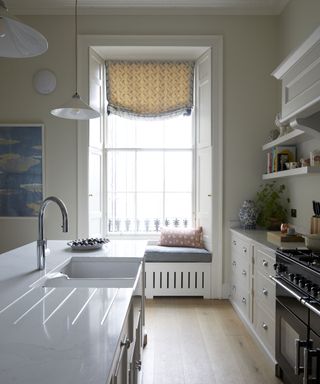 white kitchen with windowseat in Edinburgh Georgian townhouse designed by Jessica Buckley