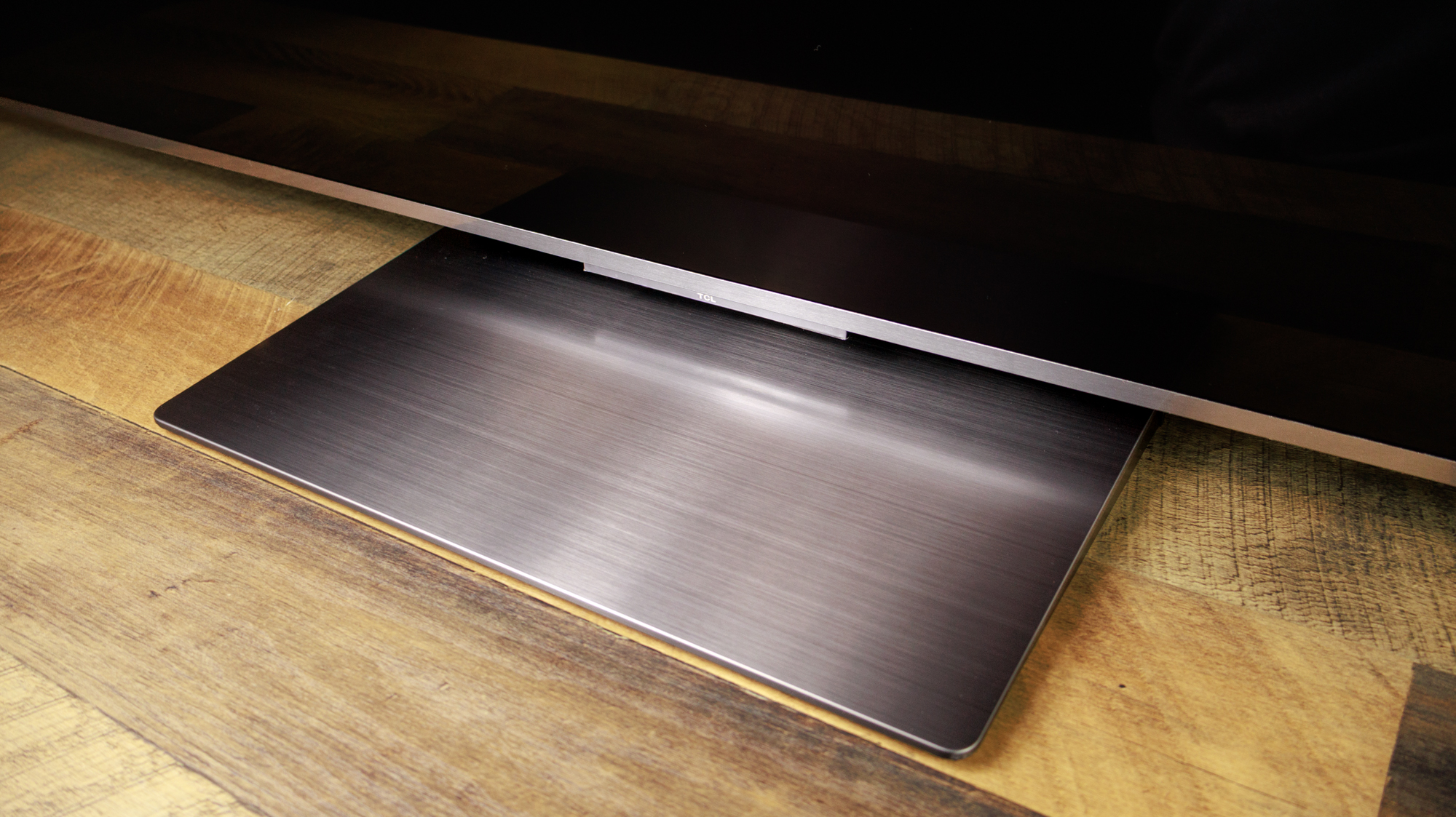 The foot of a TCL QM8L TV