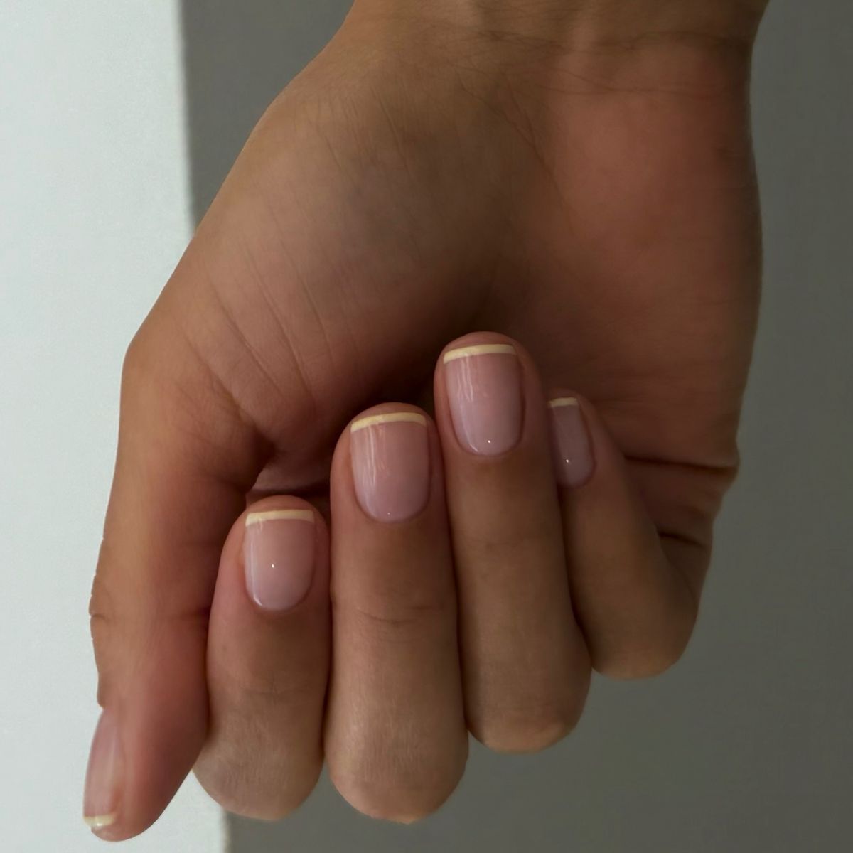 A butter yellow French tip manicure