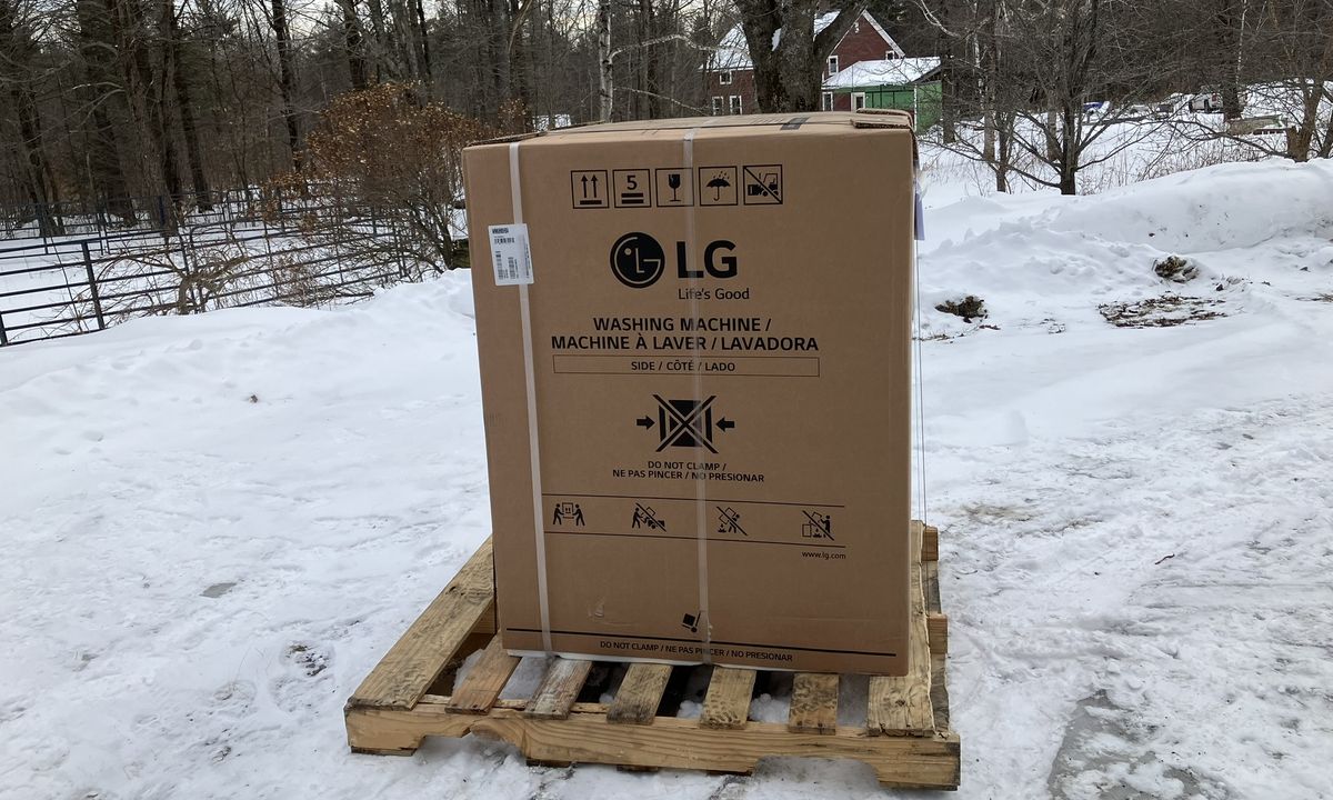 LG 5.0 cu. ft. Mega Capacity Smart Front Load All-in-One Washer Dryer Combo delivery in cardboard box on pallet