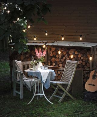 festoon lights from lights4fun by bistro and vase of flowers