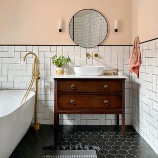 bathroom with pink wall mirror and basin