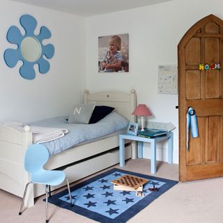 childrens bedroom with table lamp and wooden door