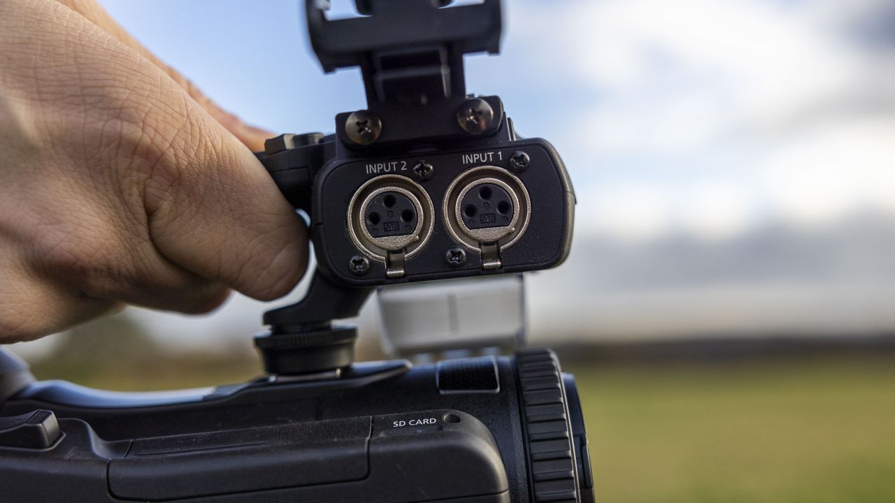 The two XLR mic ports on the handle of the Canon XA75 camcorder