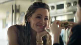Hollis smiling watching her daughter eat a sandwich in The Five-Star Weekend.