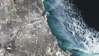A satellite photo showing ethereal ice swirls along the shoreline of Chicago in Winter