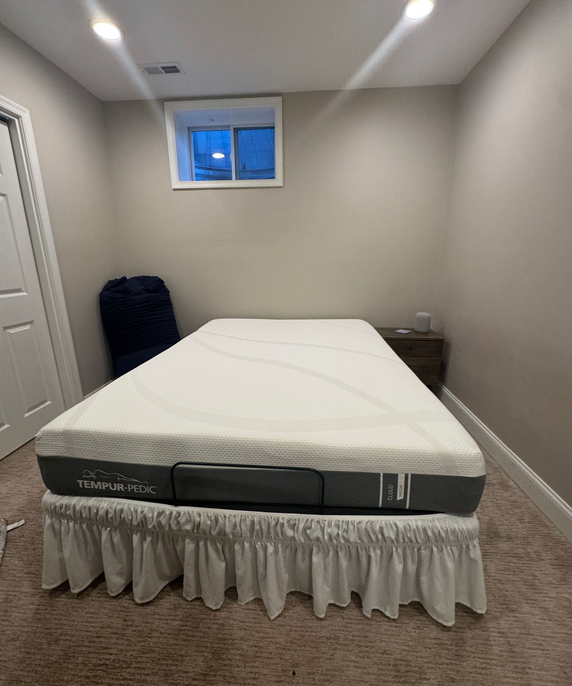 TEMPUR-Cloud Mattress on a bed in a room with white walls.