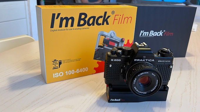 Camera with I'm Back attached, in front of I'm Back product box