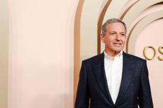 Bob Iger wears a suit walking on the Oscars Nominees Luncheon Red Carpet.