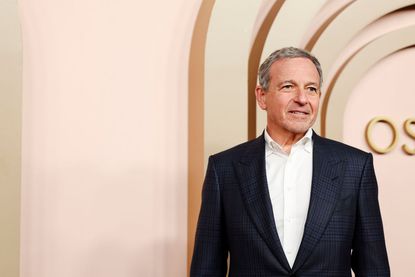 Bob Iger wears a suit walking on the Oscars Nominees Luncheon Red Carpet.