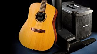 Acoustic guitar next to BOSE L1 Compact PA system