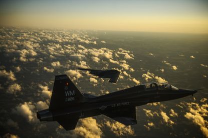 A U.S. Air Force T-38 Talon aircraft and B-2 Spirit aircraft fly in formation during a training mission