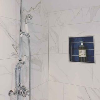 bathroom with white tiles shower and faucet