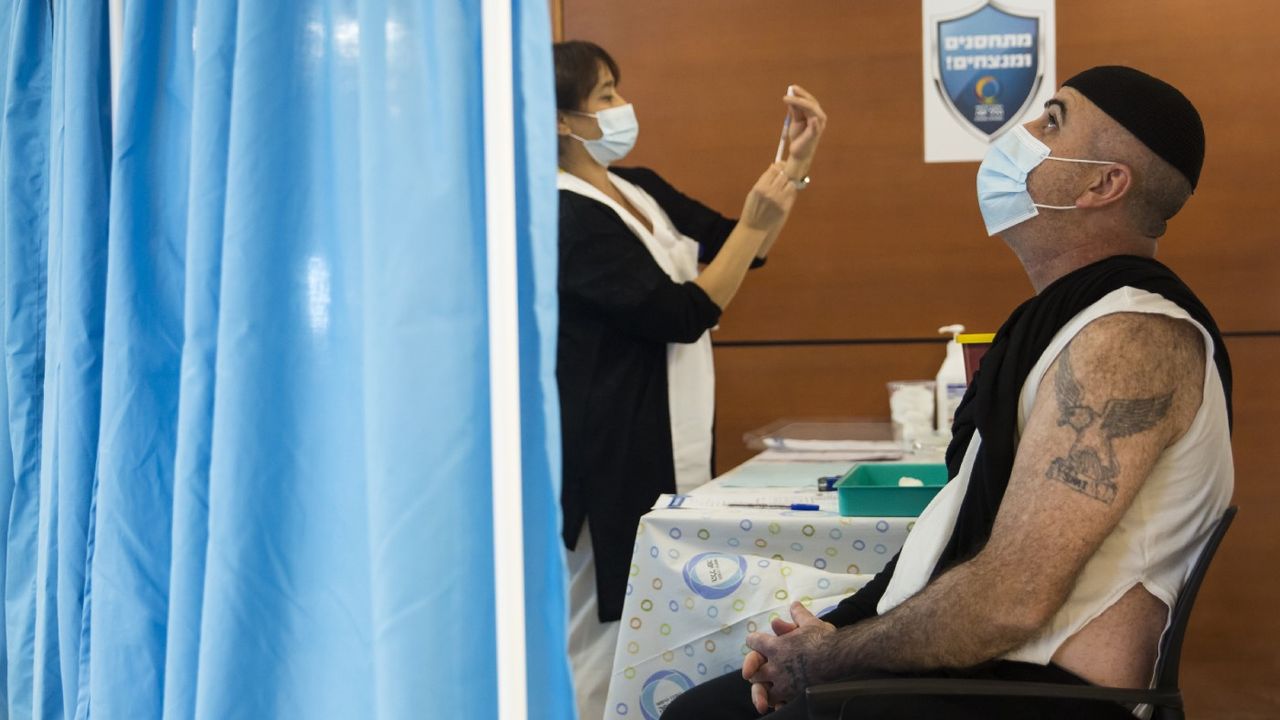 A patient awaits a vaccine jab at a mass vaccination centre in Tel-Aviv