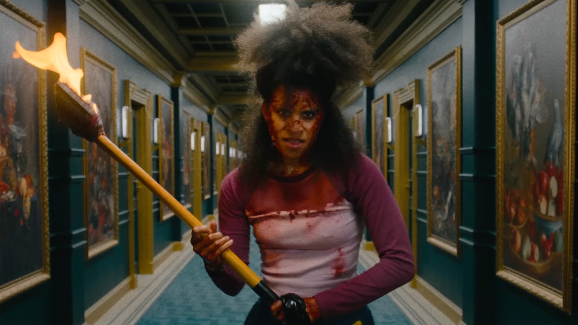 Asia Reeves about to exact justice with a burning axe.