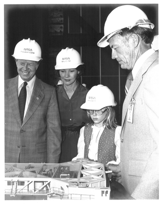 President Carter, wife Rosalynn and daughter Amy are shown a scale model of the crawler that transported the total shuttle launch configuration to Pad 39 from the Vehicle Assembly Building by NASA’s Kennedy Space Center Director Lee Scherer in 1978.