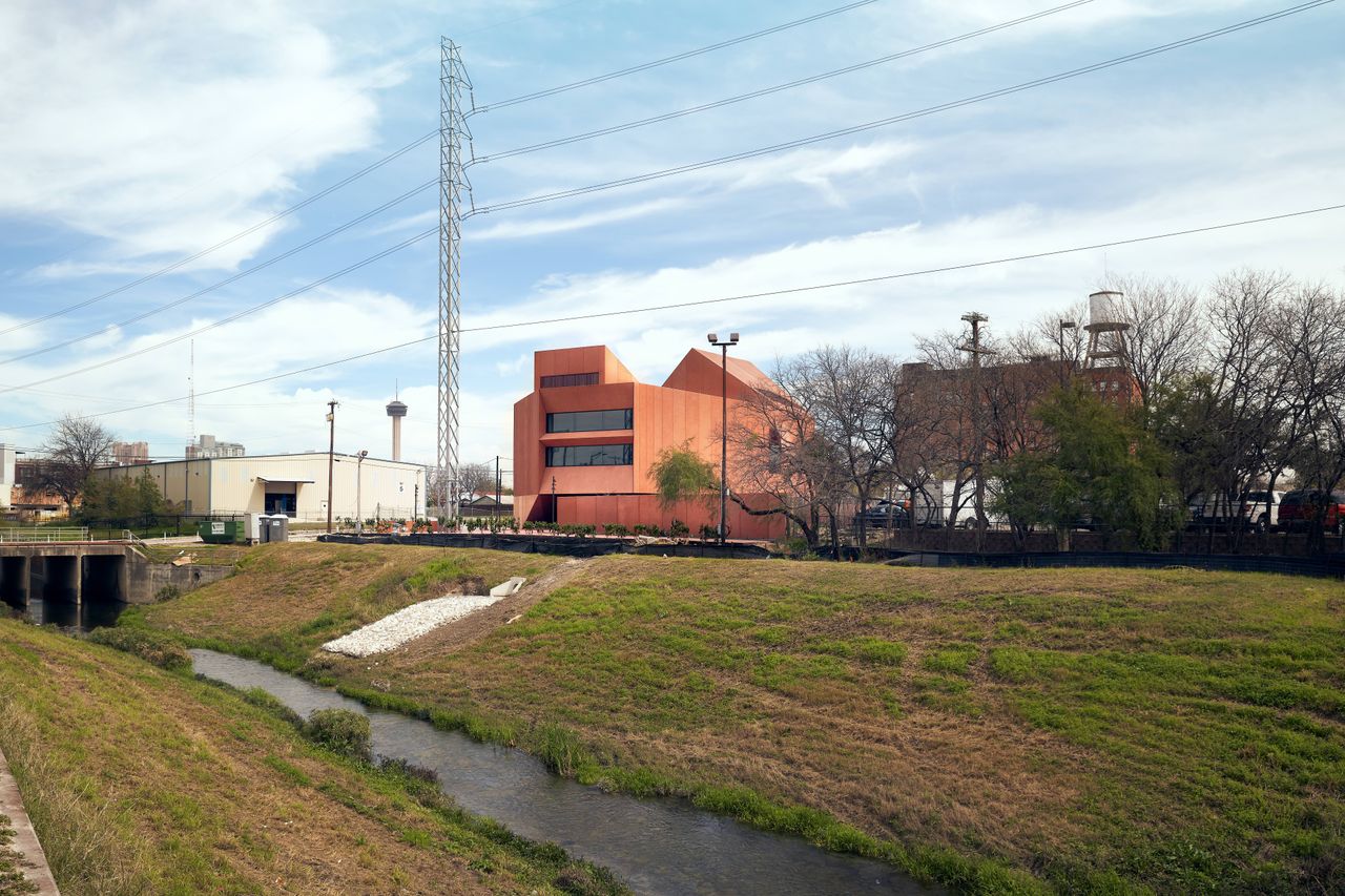 Cultural building near stream with orange exterior