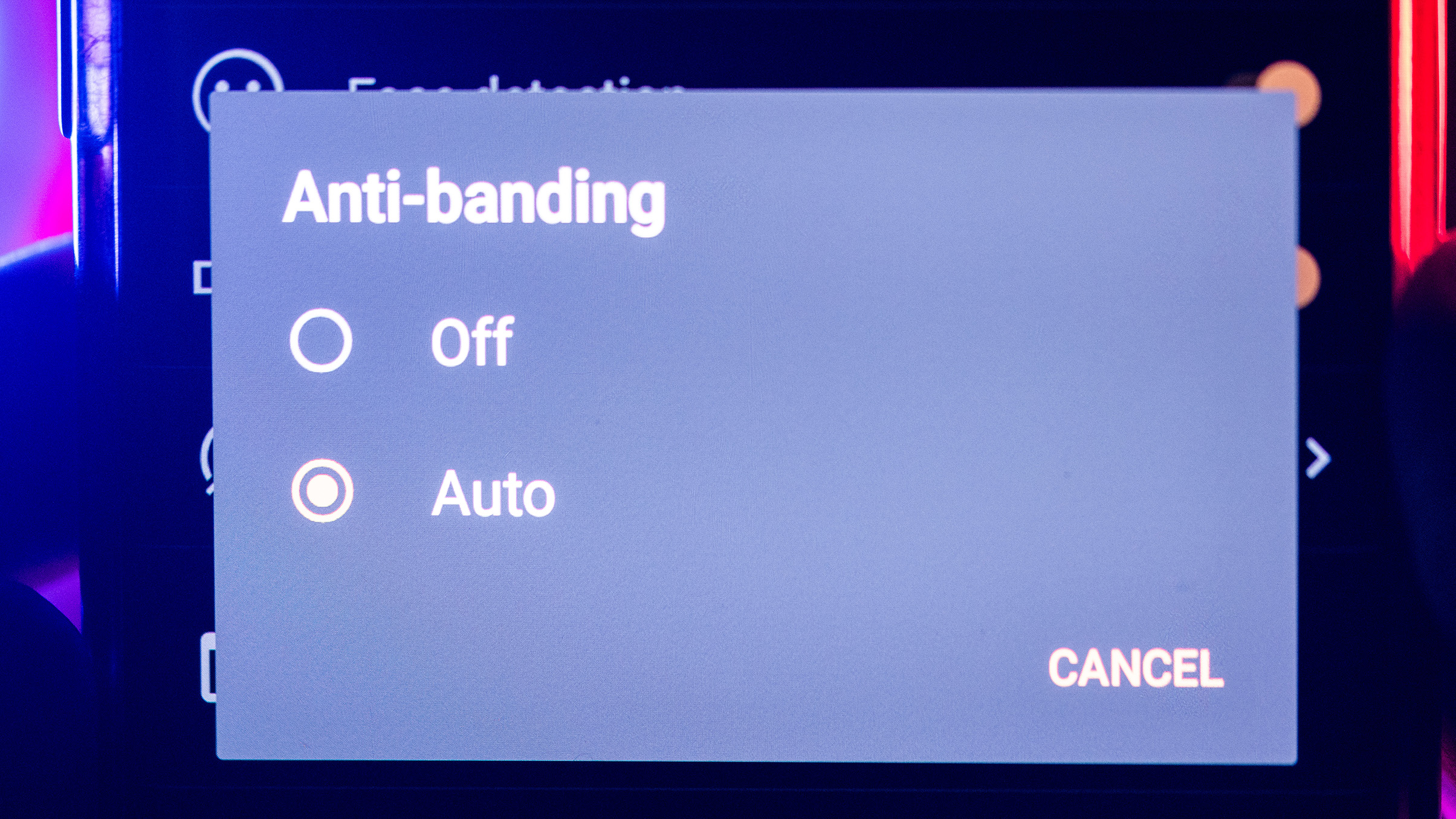 A smartphone screen displaying the "Anti-banding" menu with options to select "Off" or "Auto," and a "Cancel" button visible