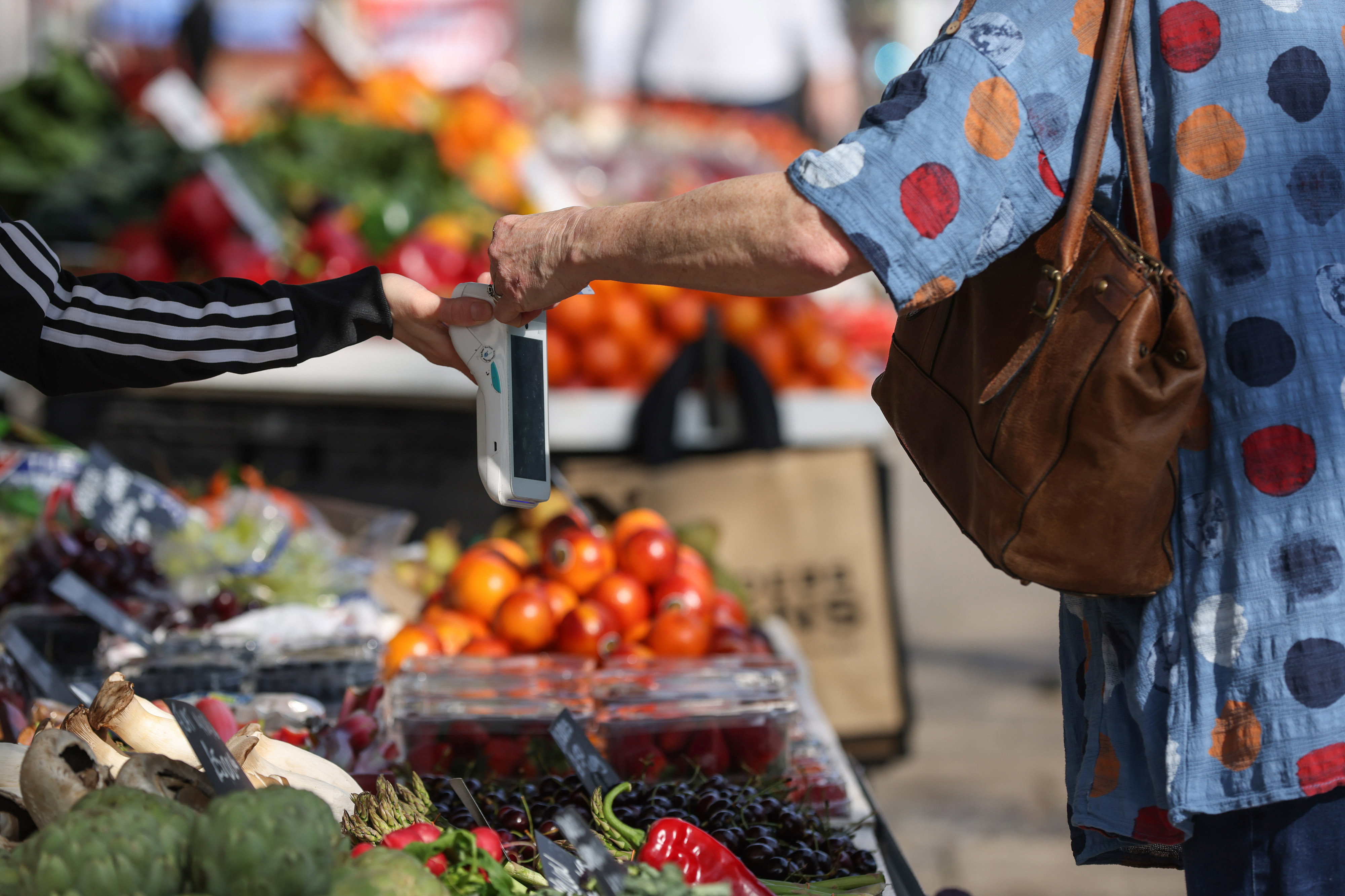 Person paying at market with contactless