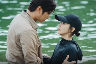 na in-woo as yoo ji-hyuk and park min-young as kang ji-won, standing in a lake, in the k-drama 'marry my husband'