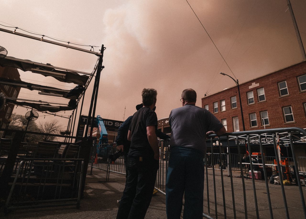 Organisers gaze at the smoke-filled sky as wildfires rage to the west of Stillwater
