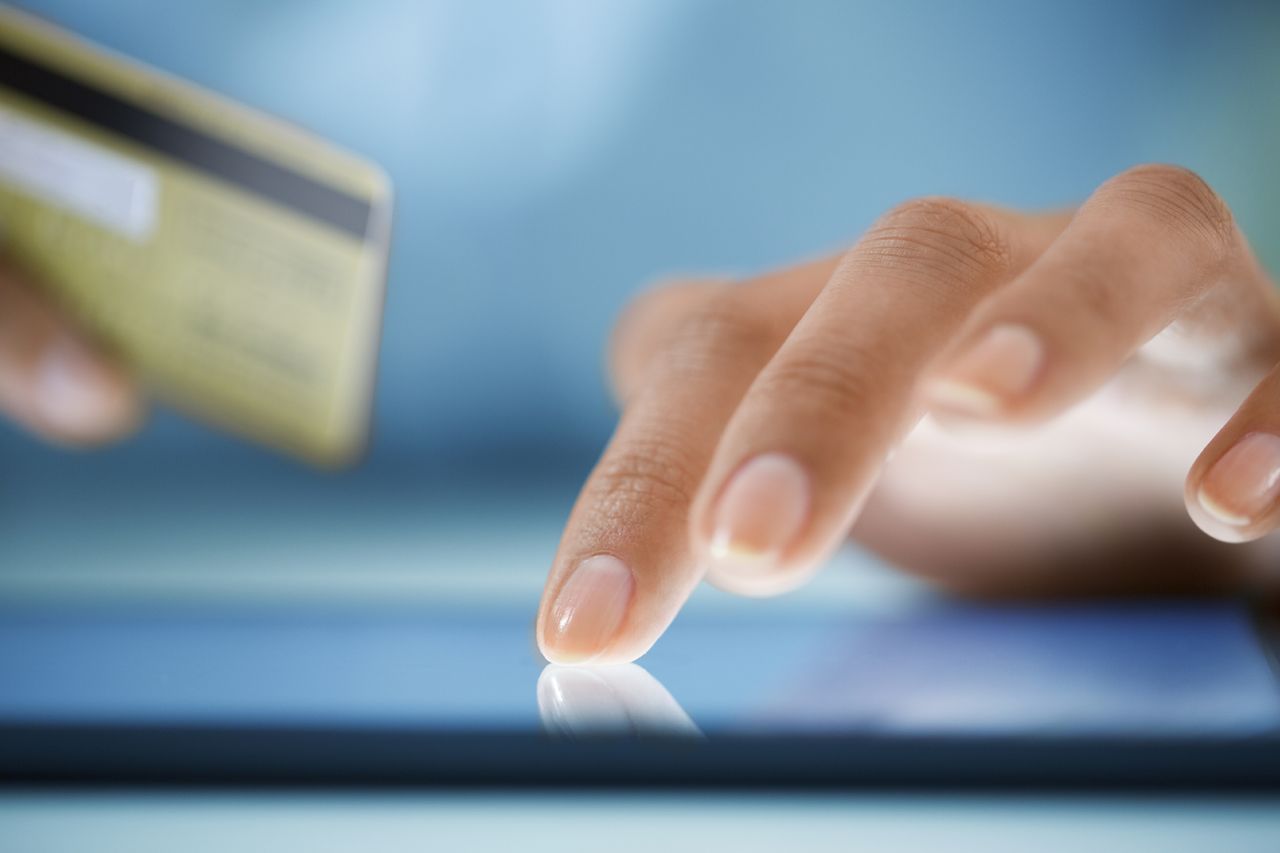 A woman completes a transaction.