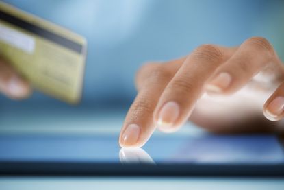 A woman completes a transaction.