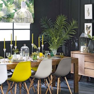 tropical themed dining room with palm and fern prints, set against a charcoal backdrop