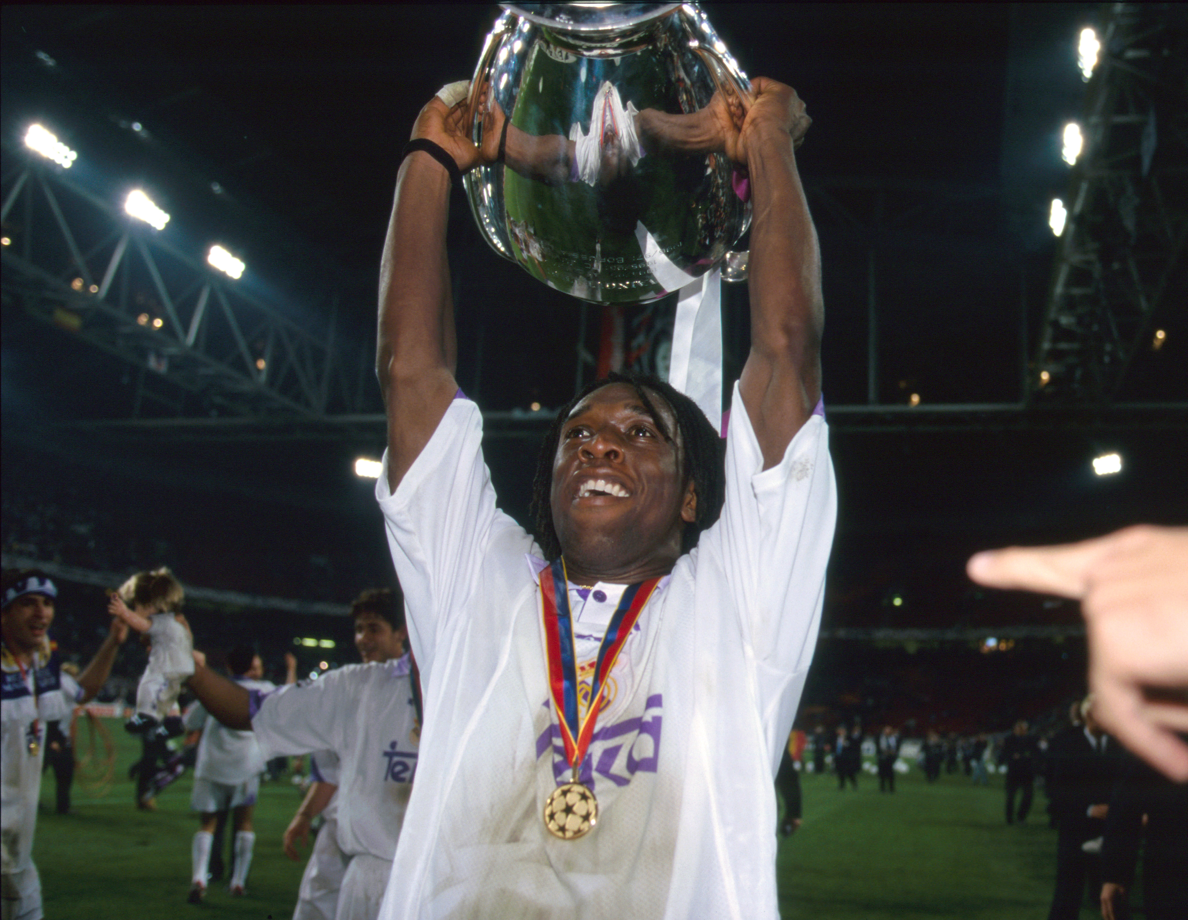 Clarence Seedorf celebrates with the Champions League trophy after Real Madrid's win over Juventus in the 1998 final.