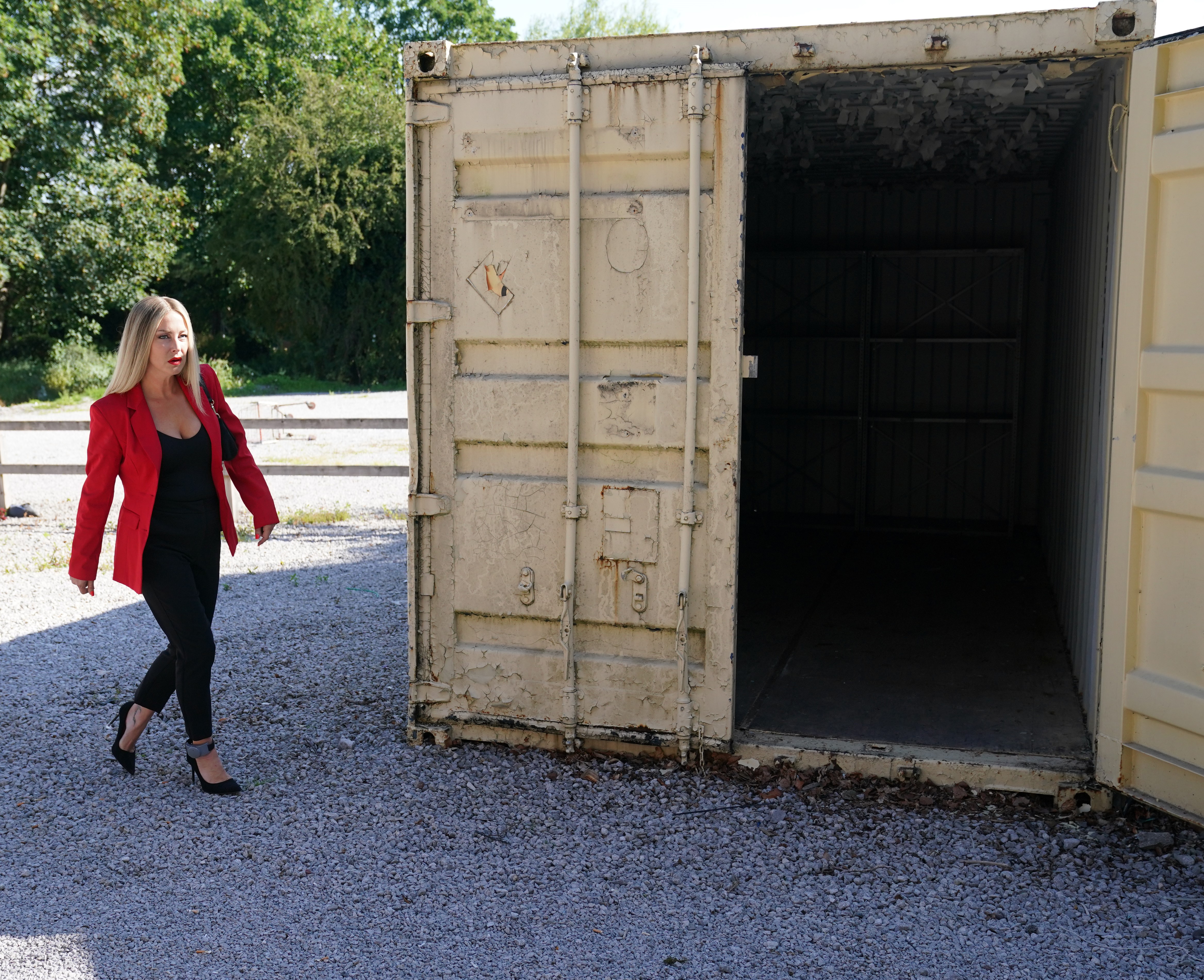 Clare Devine walking towards a storage unit.