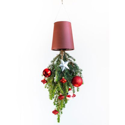 upside down plant pot with christmas decorated plant hanging on wall