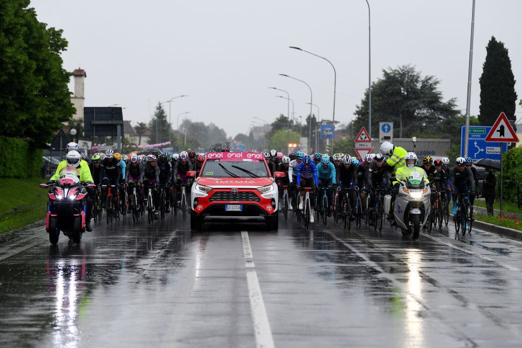 CORTINA DAMPEZZO ITALY MAY 24 Aleksander Vlasov of Russia and Team Astana Premier Tech white best young jersey Geoffrey Bouchard of France and AG2R Citren Team blue mountain jersey the peloton in neutralised start during the 104th Giro dItalia 2021 Stage 16 a 153km stage shortened due to bad weather conditions from Sacile to Cortina dAmpezzo 1210m Rain girodiitalia Giro on May 24 2021 in Cortina dAmpezzo Italy Photo by Tim de WaeleGetty Images